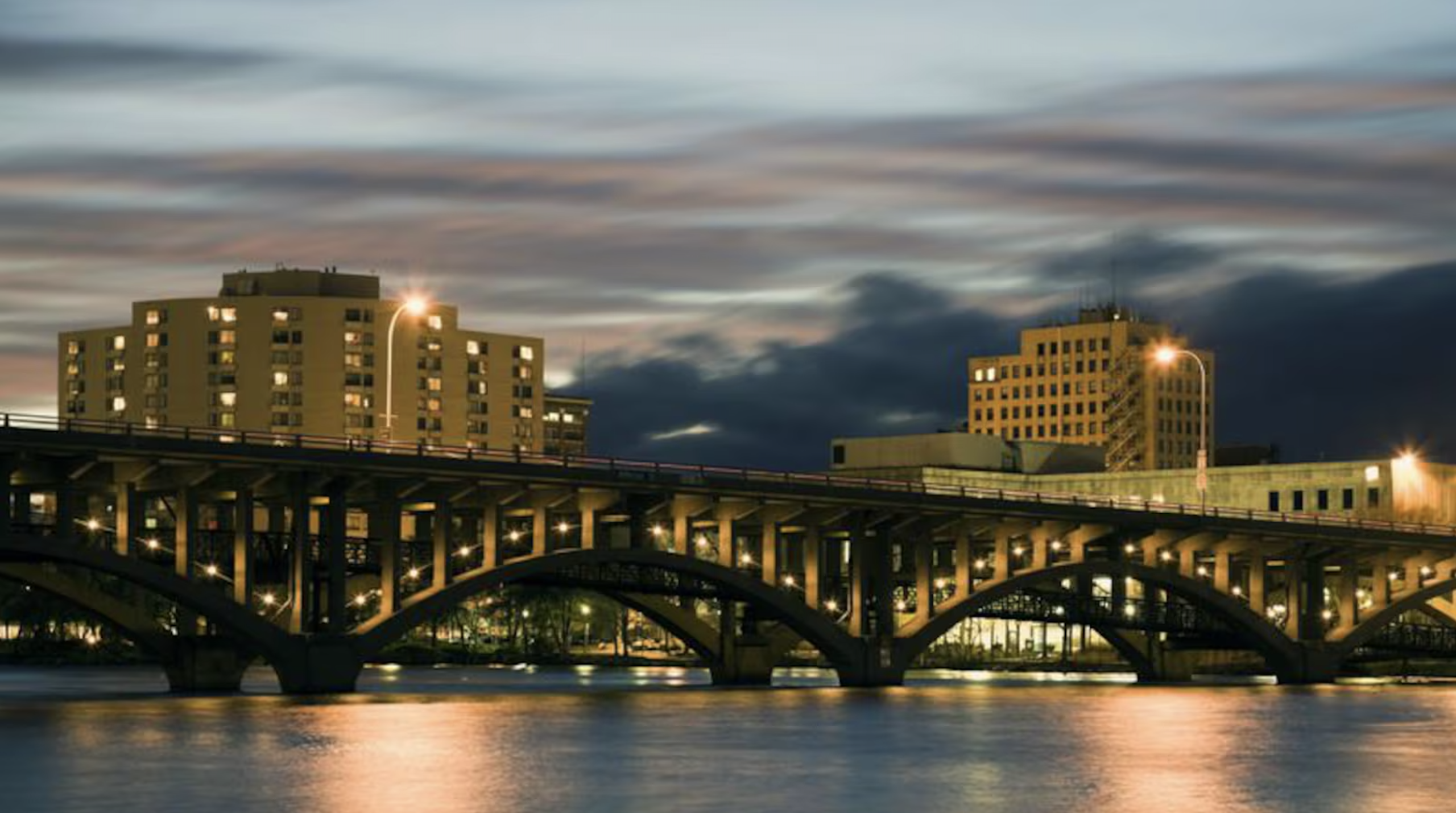 A person working on a laptop beside a stethoscope